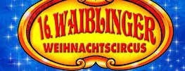 Auf einem farbenfrohen Schild mit gelbem und rotem Rand steht "16. Waiblinger Weihnachtscircus" vor einem blauen Hintergrund mit sternförmigem Glitzern, das den festlichen Geist des Waiblinger Weihnachtscircus feiert.